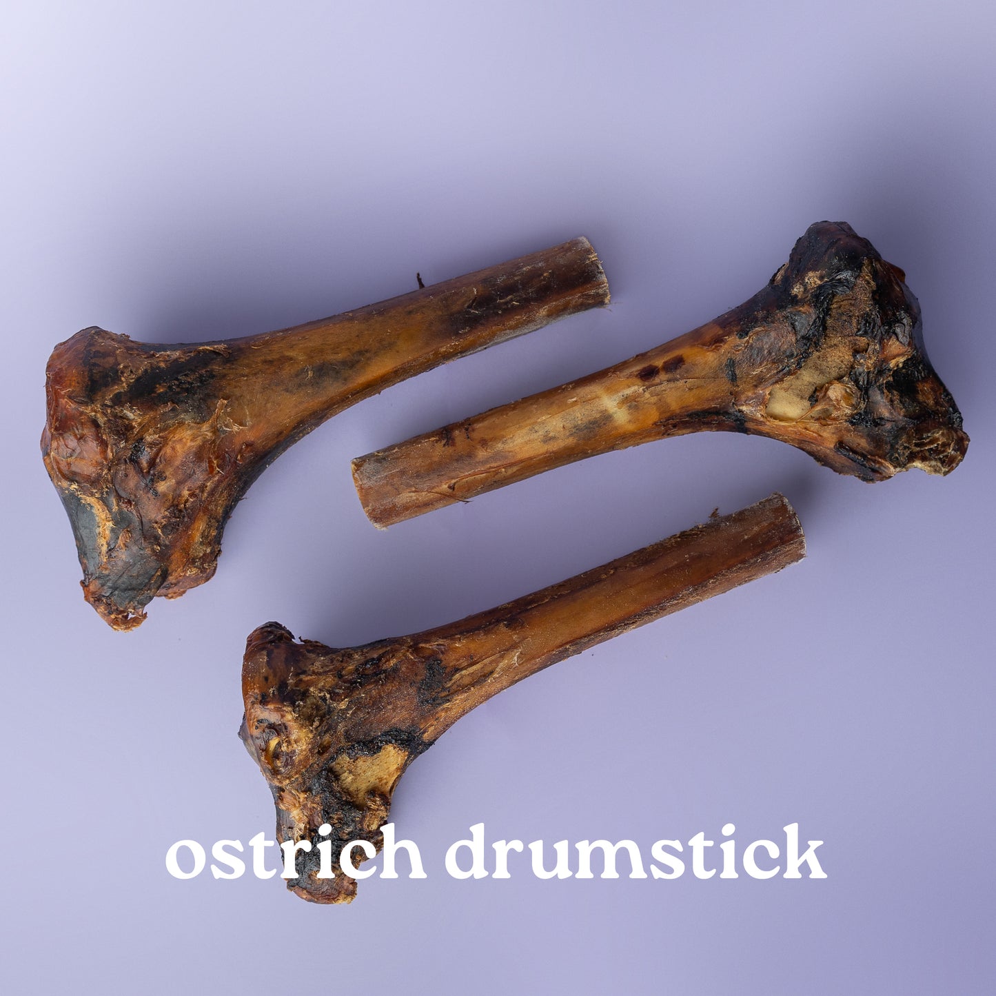 Three ostrich drumsticks on a purple background with 'ostrich drumstick' text.