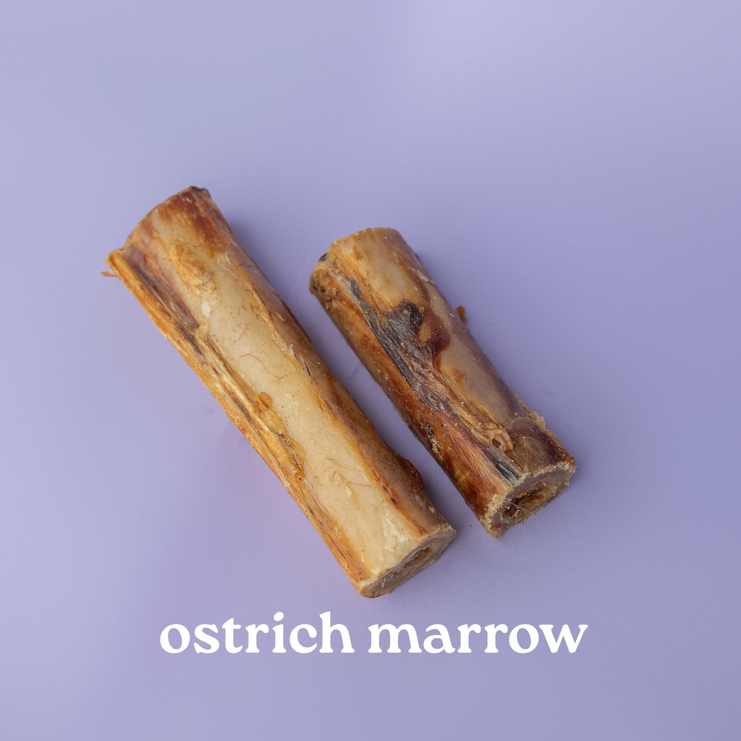 Two pieces of ostrich marrow on a purple background with 'ostrich marrow' text.