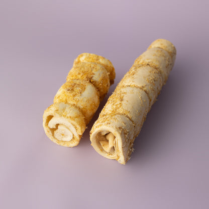A bundle of rolled beef cheek dog chews, dusted with bully stick powder, against a purple background, rawhide alternative for dogs, beef cheek roll for dogs