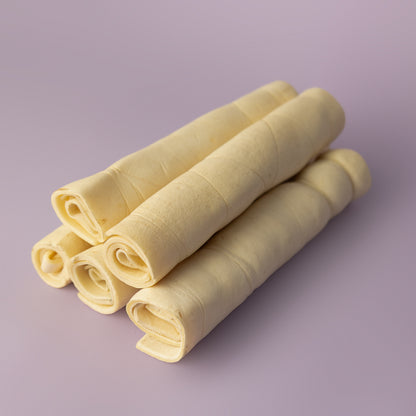rawhide alternative, power chew for dogs, beef cheek roll for dogs, long lasting dog chew on purple background