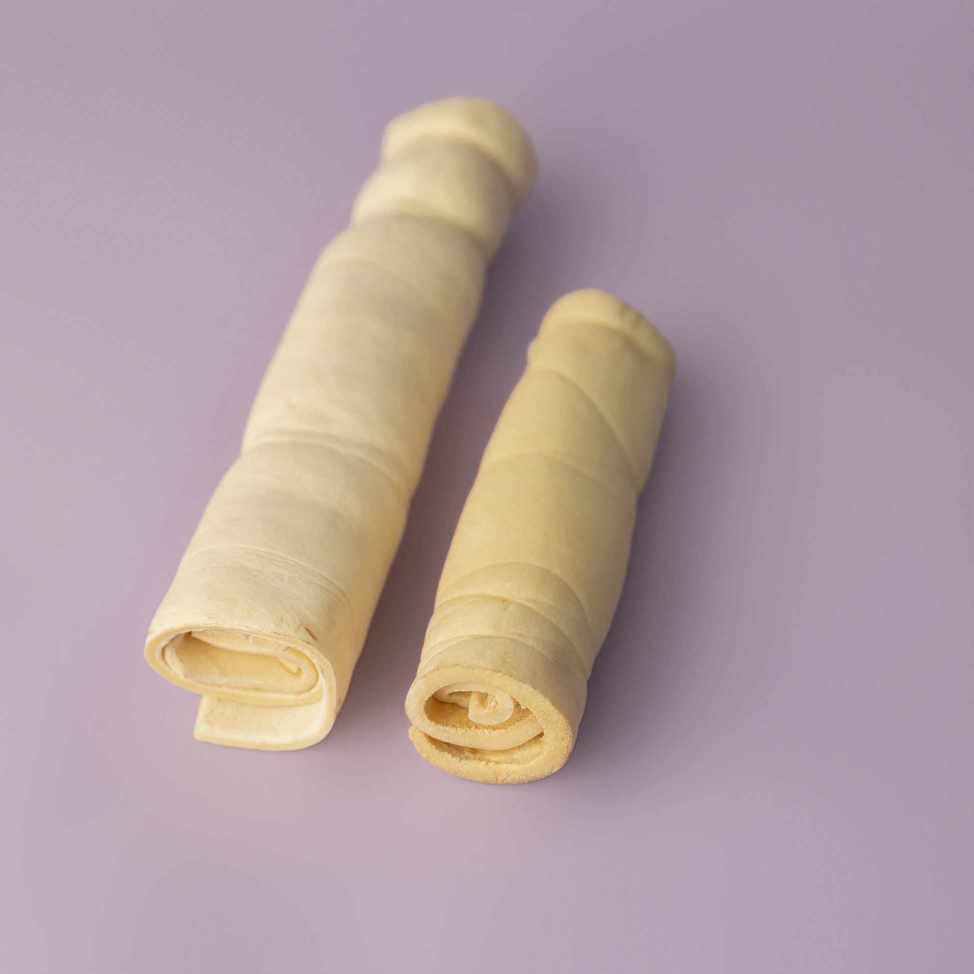 rawhide alternative, power chew for dogs, beef cheek roll for dogs, long lasting dog chew on purple background