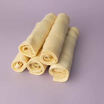 rawhide alternative, power chew for dogs, beef cheek roll for dogs, long lasting dog chew on purple background