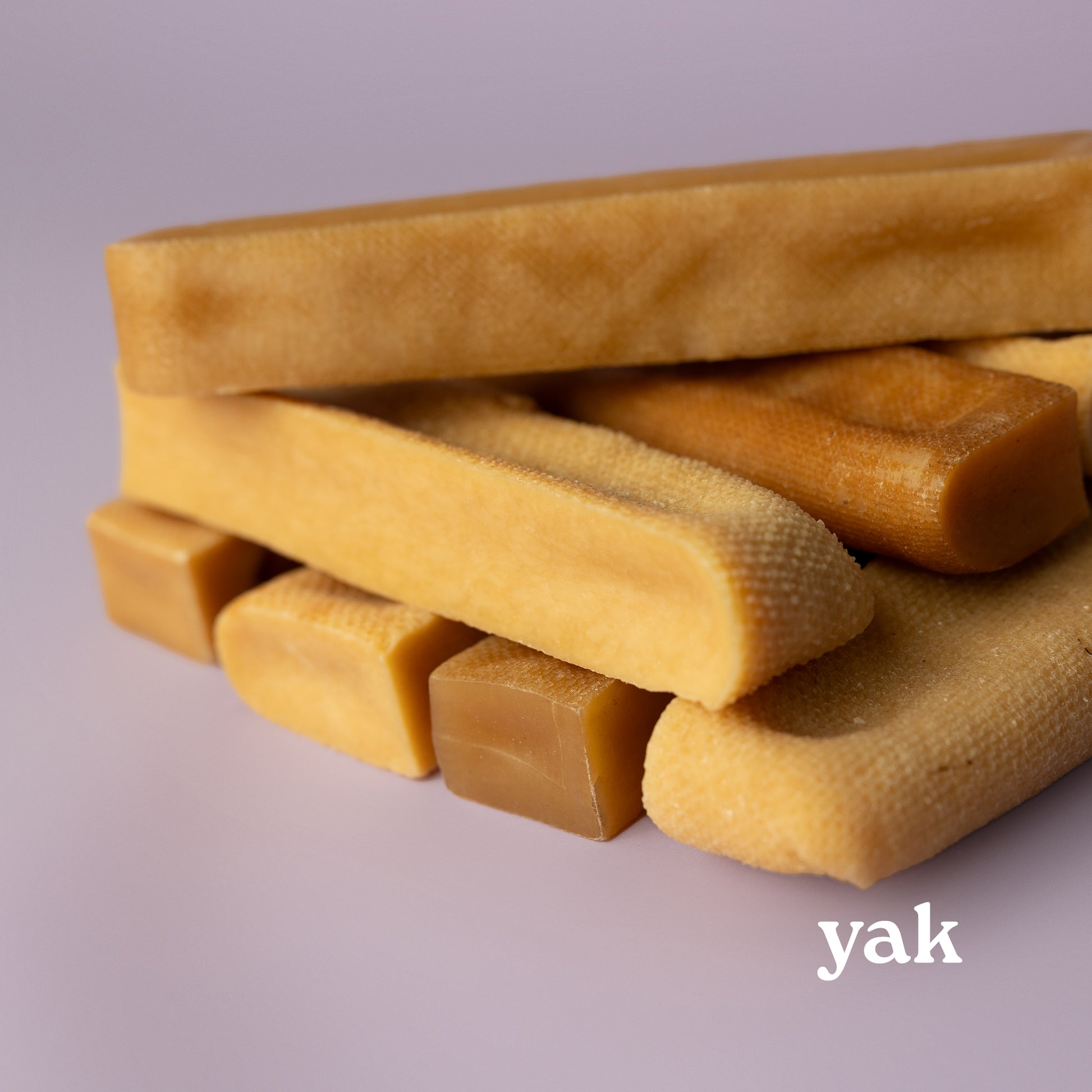 stacked yak chews on purple background, power chew for dogs, power chew for pitbulls, strong dog chew, best value dog chew, long lasting dog chew