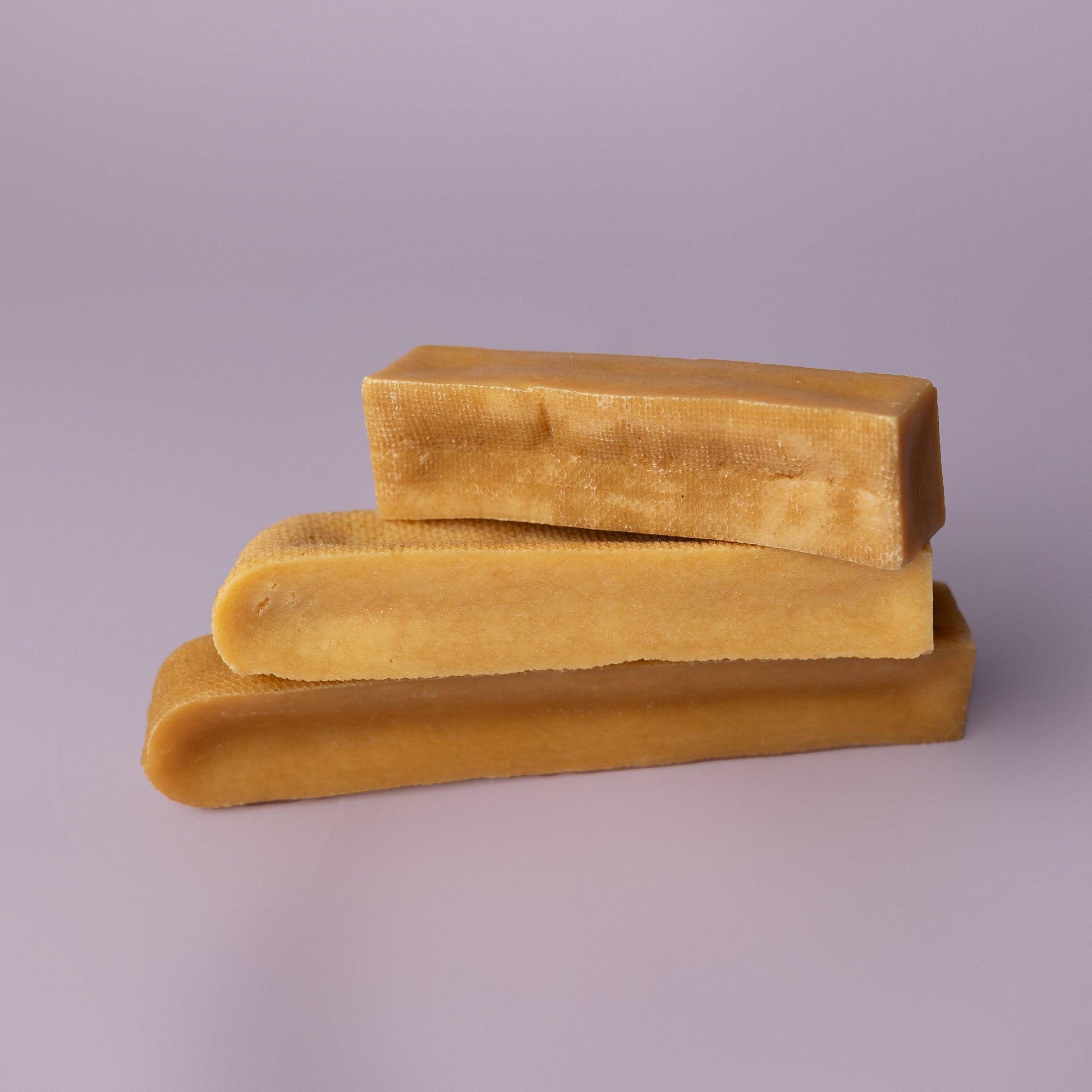 stacked yak chews on purple background, power chew for dogs, power chew for pitbulls, strong dog chew, best value dog chew, long lasting dog chew