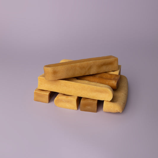stacked yak chews on purple background, power chew for dogs, power chew for pitbulls, strong dog chew, best value dog chew, long lasting dog chew